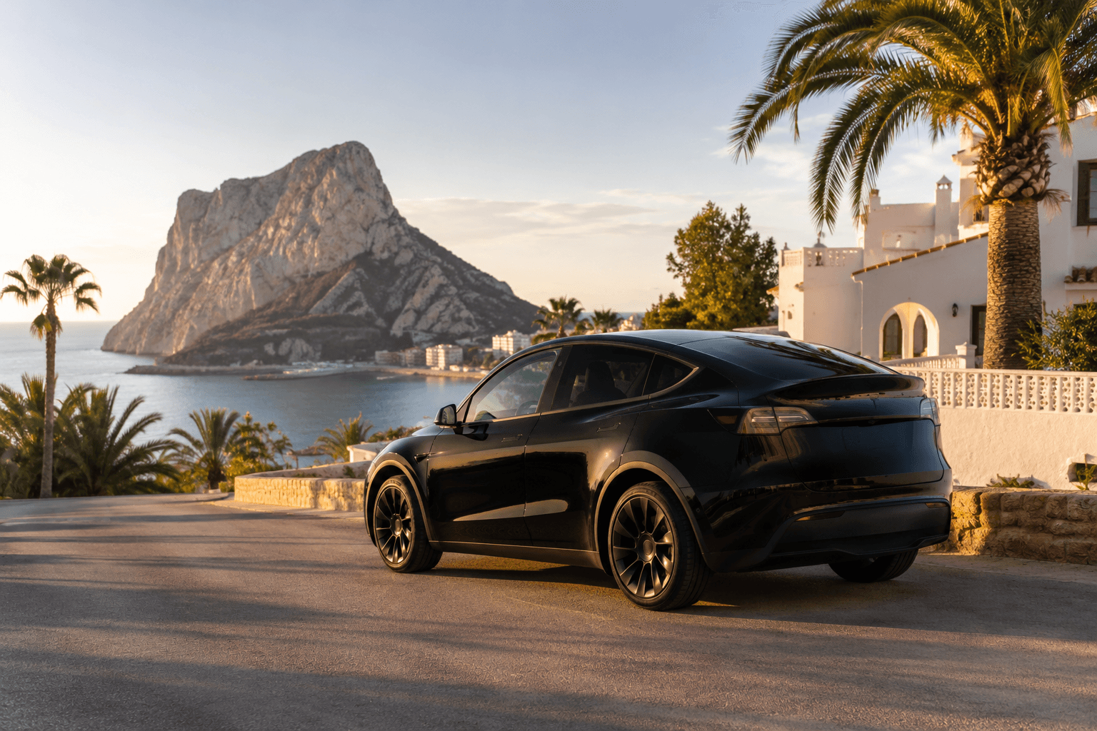 Alicante Airport to Calpe transfer, private electric Tesla with the Penyal d'Ifac in the background