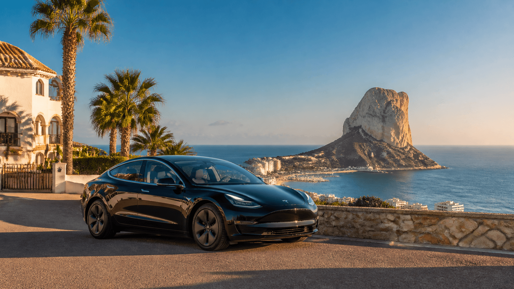 Valencia Airport to Calpe transfer, private electric Tesla with the Penyal d'Ifac in the background